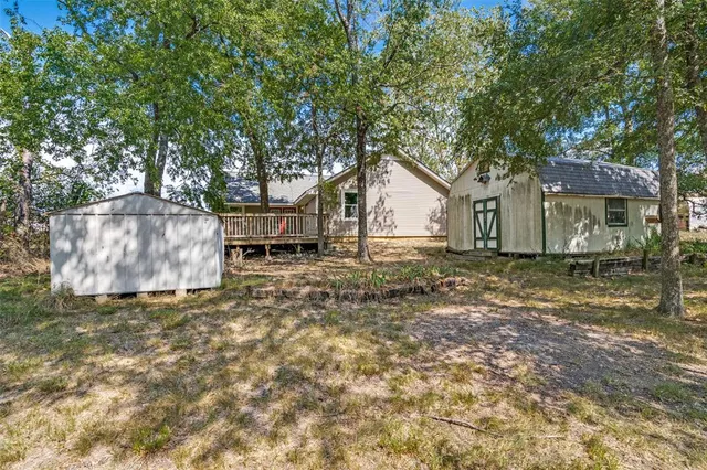 a backyard of a house with table and chairs
