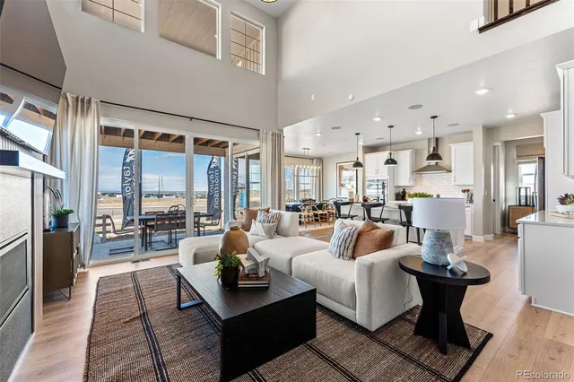 a view of a dining room with furniture a chandelier and wooden floor