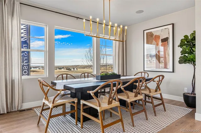 a kitchen with stainless steel appliances kitchen island wooden floors and white cabinets