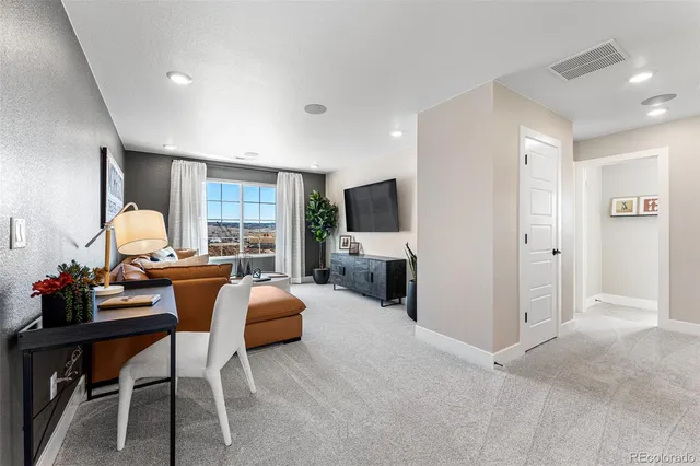 a spacious bedroom with a bed a dresser and potted plants