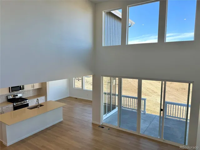a living room with furniture and a floor to ceiling window