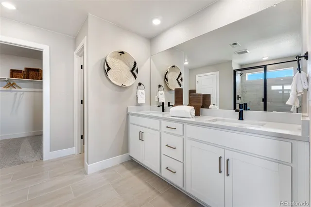 a bedroom with a bed mirror and window