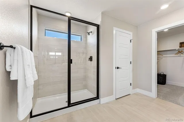 a bedroom with a bed and a lamp