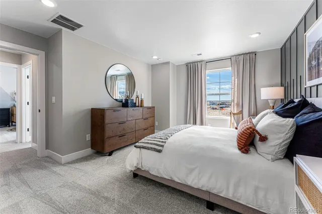 a bathroom with a double vanity sink a toilet and a mirror