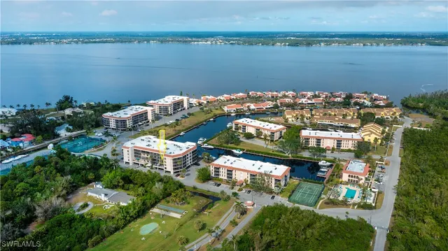 an aerial view of lake and residential houses with outdoor space