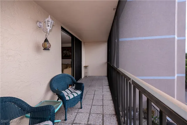 a view of staircase with wooden floor and chair