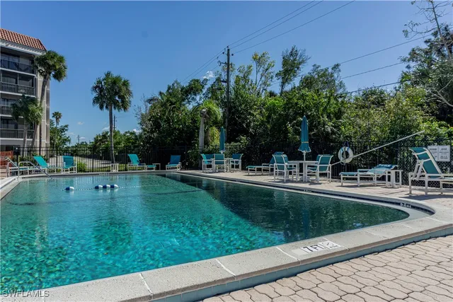 a view of a swimming pool with a garden and trees