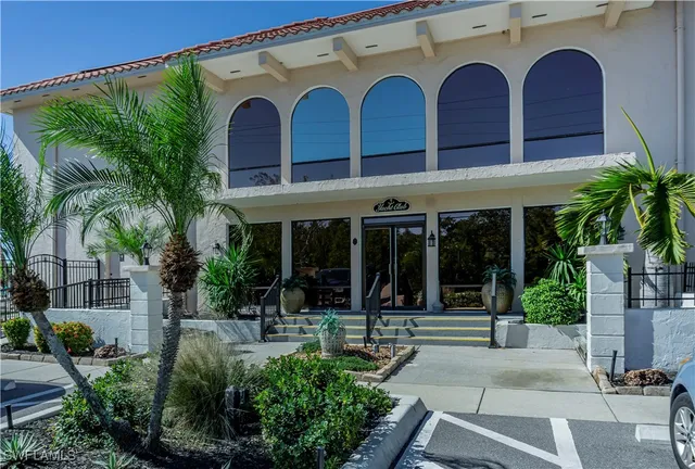 a view of building with potted plants