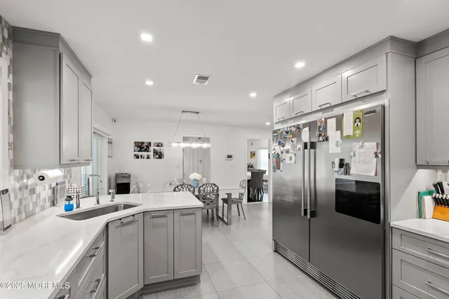 a kitchen with stainless steel appliances granite countertop a stove sink microwave and cabinets