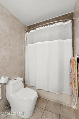 a bedroom with two beds and a window