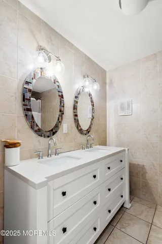 a bedroom with two beds and a potted plant