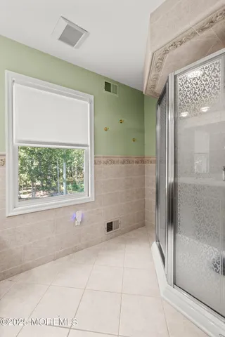 a view of a room with furniture and large windows