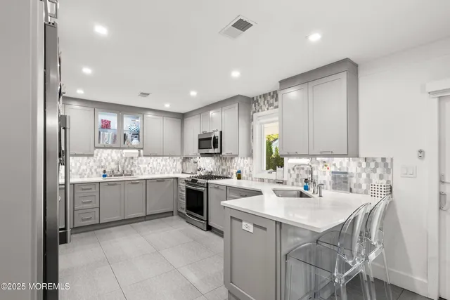 a kitchen with a sink stove and microwave