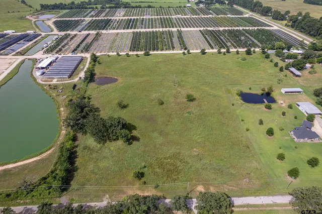 a view of a big yard with a house in the background