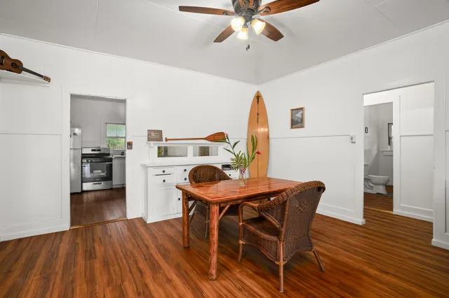 a view of a dining room with furniture and wooden floor