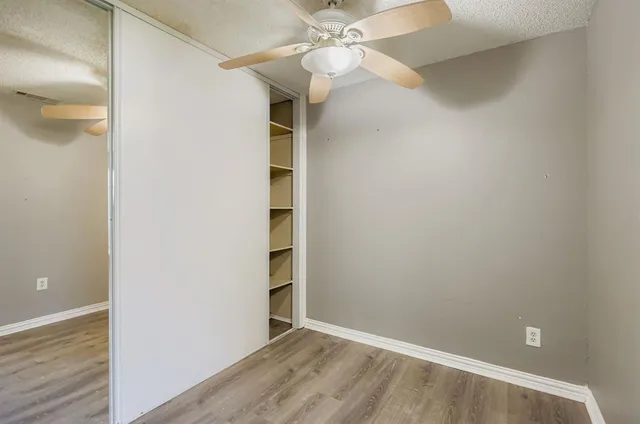 an empty room with a empty space and a ceiling fan