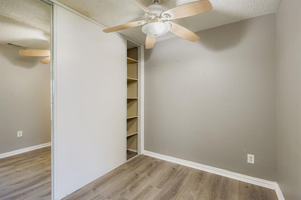 2400 Jupiter Road, Unit I2 Plano, TX 75074 - Photo 14 of 28 an empty room with a empty space and a ceiling fan