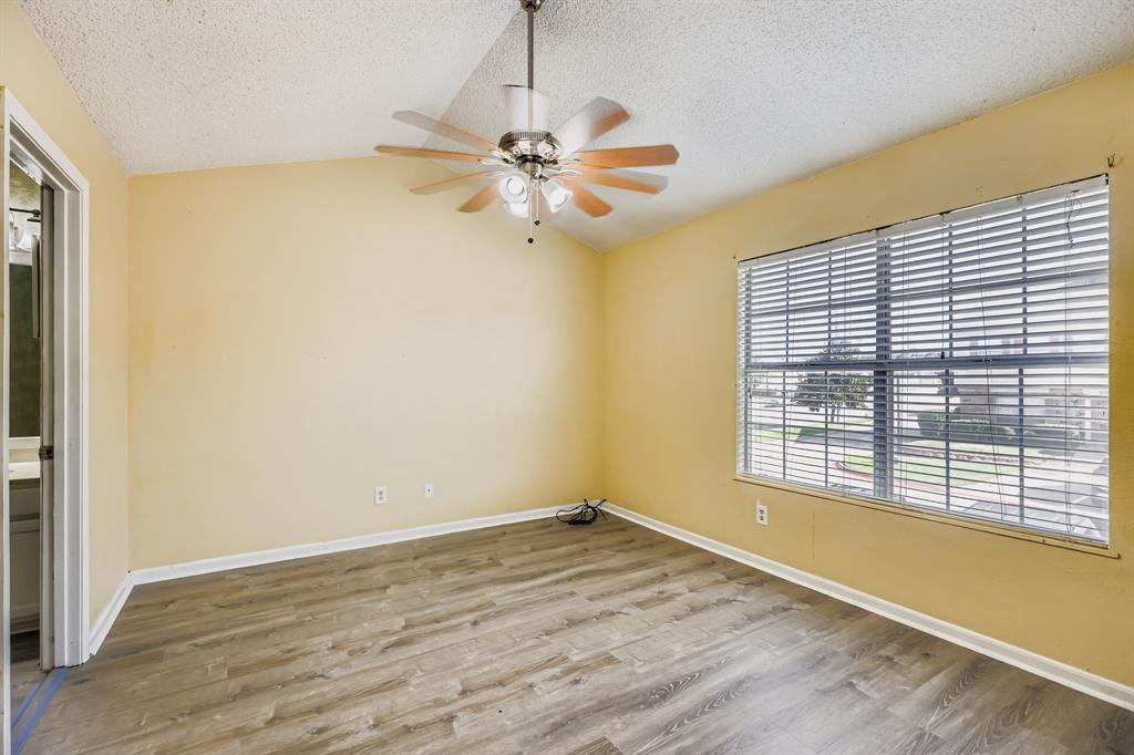 2400 Jupiter Road, Unit I2 Plano, TX 75074 - Photo 18 of 28 a view of empty room with wooden floor and fan