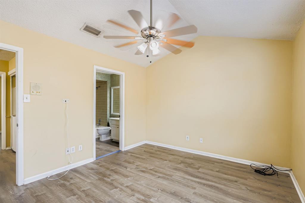 2400 Jupiter Road, Unit I2 Plano, TX 75074 - Photo 19 of 28 a view of a room with a ceiling fan and a hardwood floor