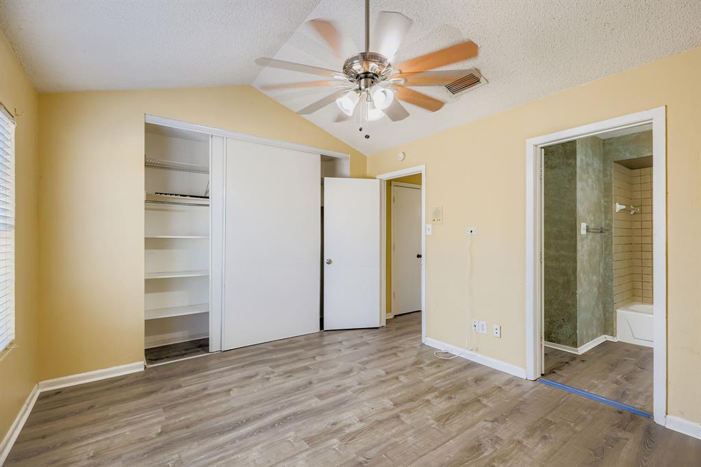 2400 Jupiter Road, Unit I2 Plano, TX 75074 - Photo 20 of 28 an empty room with a ceiling fan and wooden floor