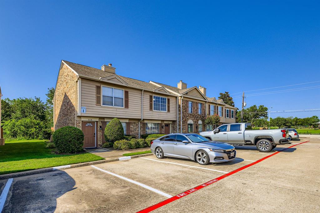 2400 Jupiter Road, Unit I2 Plano, TX 75074 - Photo 2 of 28 a view of a cars park in front of a house