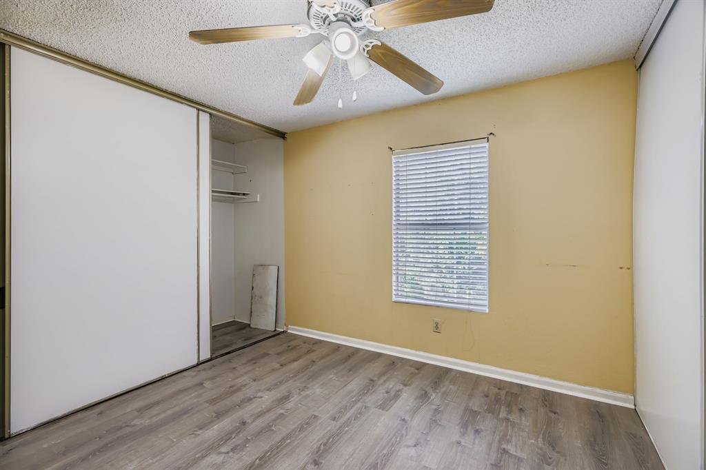 2400 Jupiter Road, Unit I2 Plano, TX 75074 - Photo 25 of 28 a view of an empty room with wooden floor and a window