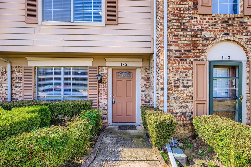 2400 Jupiter Road, Unit I2 Plano, TX 75074 - Photo 3 of 28 a front view of a house with a yard
