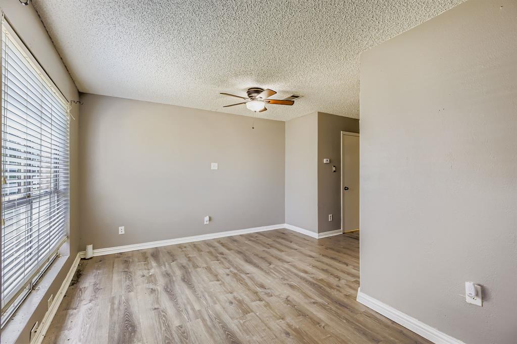 2400 Jupiter Road, Unit I2 Plano, TX 75074 - Photo 7 of 28 wooden floor in an empty room with a window