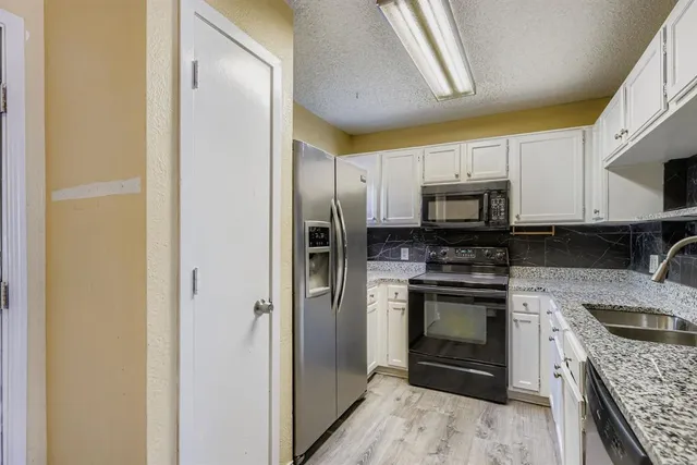 a kitchen with a refrigerator stove and sink