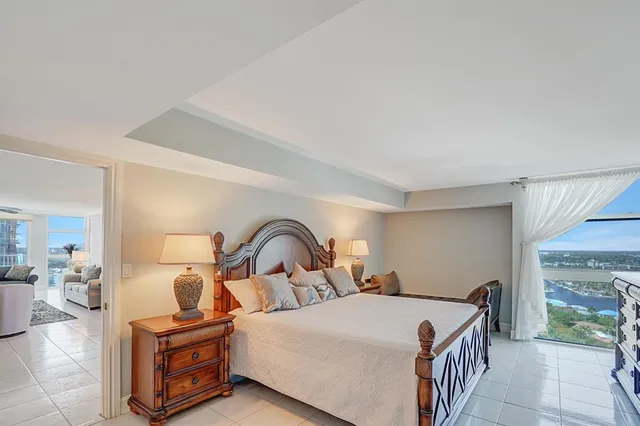 a living room with furniture and a floor to ceiling window