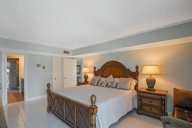 a kitchen with stainless steel appliances kitchen island granite countertop a sink a stove and a refrigerator