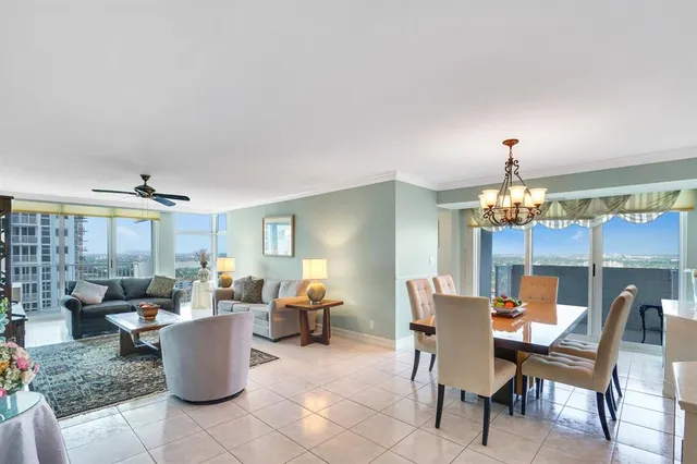 a view of a dining room with furniture a chandelier and wooden floor