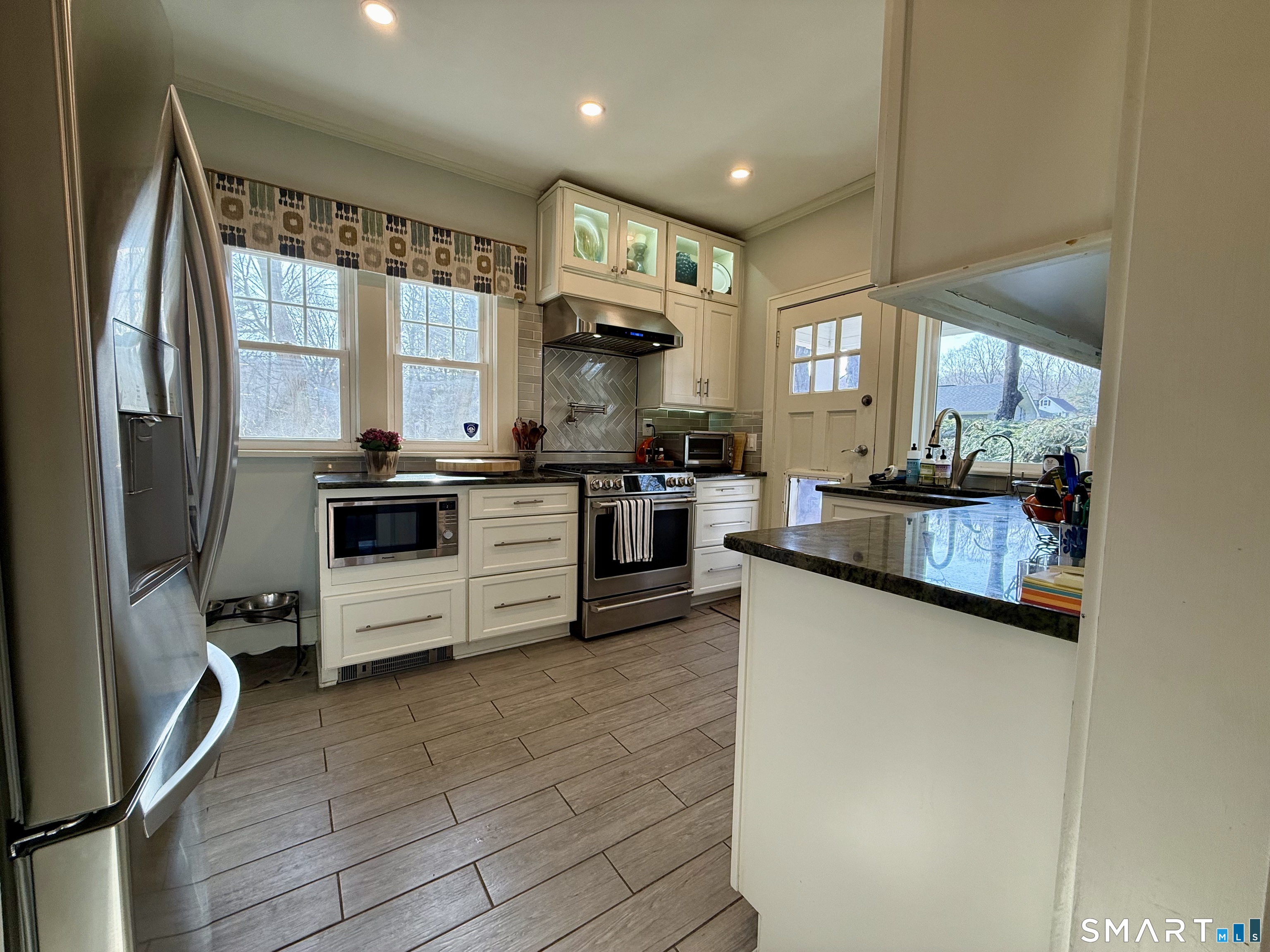 12 Sunset Pass Wilton, CT 06897 - Photo 11 of 31 a kitchen with stainless steel appliances granite countertop a stove a sink and a refrigerator