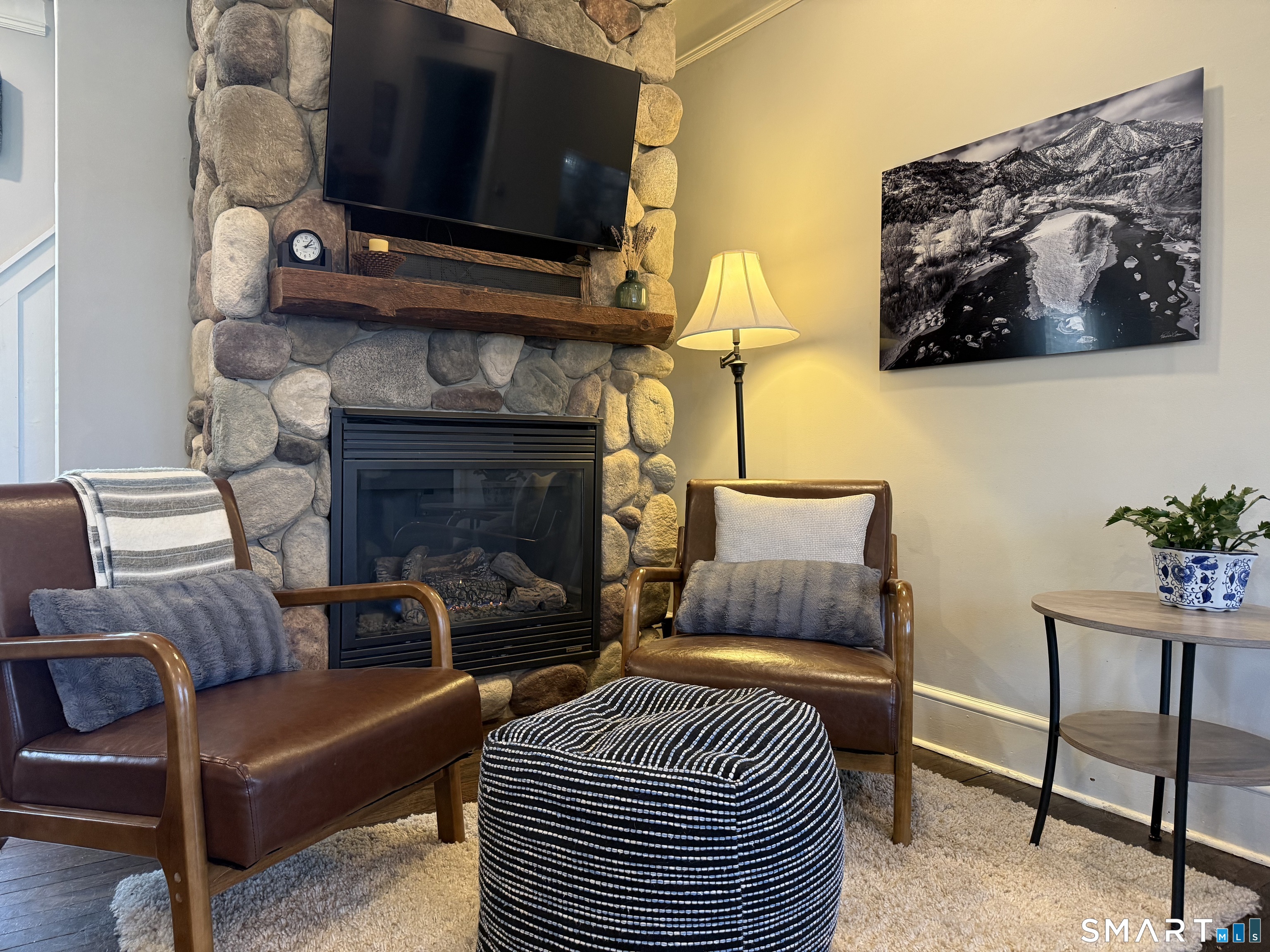 12 Sunset Pass Wilton, CT 06897 - Photo 6 of 31 a living room with furniture a flat screen tv and a fireplace