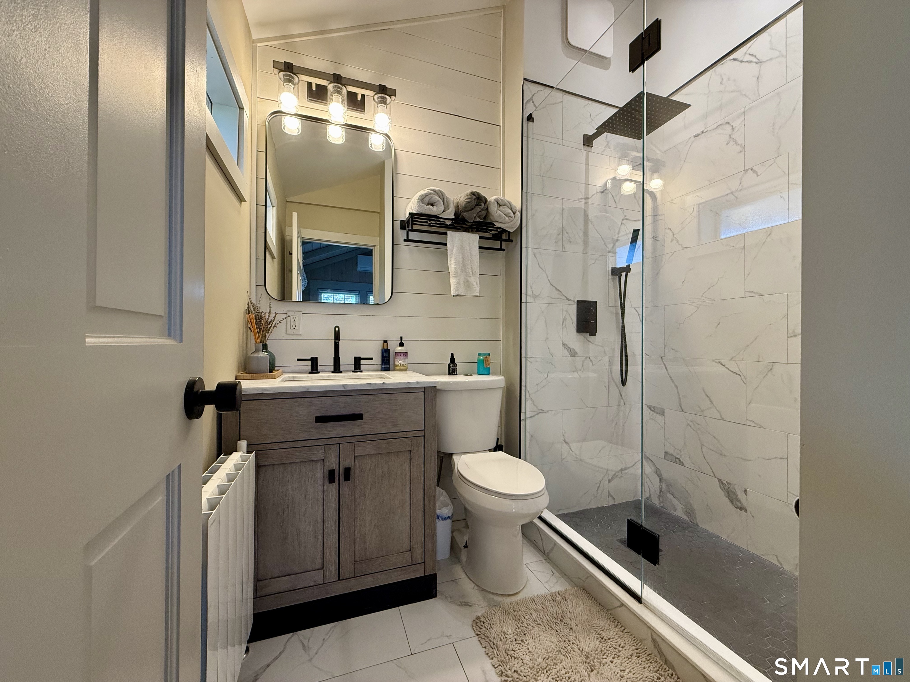 12 Sunset Pass Wilton, CT 06897 - Photo 9 of 31 a bathroom with a sink toilet a mirror and shower