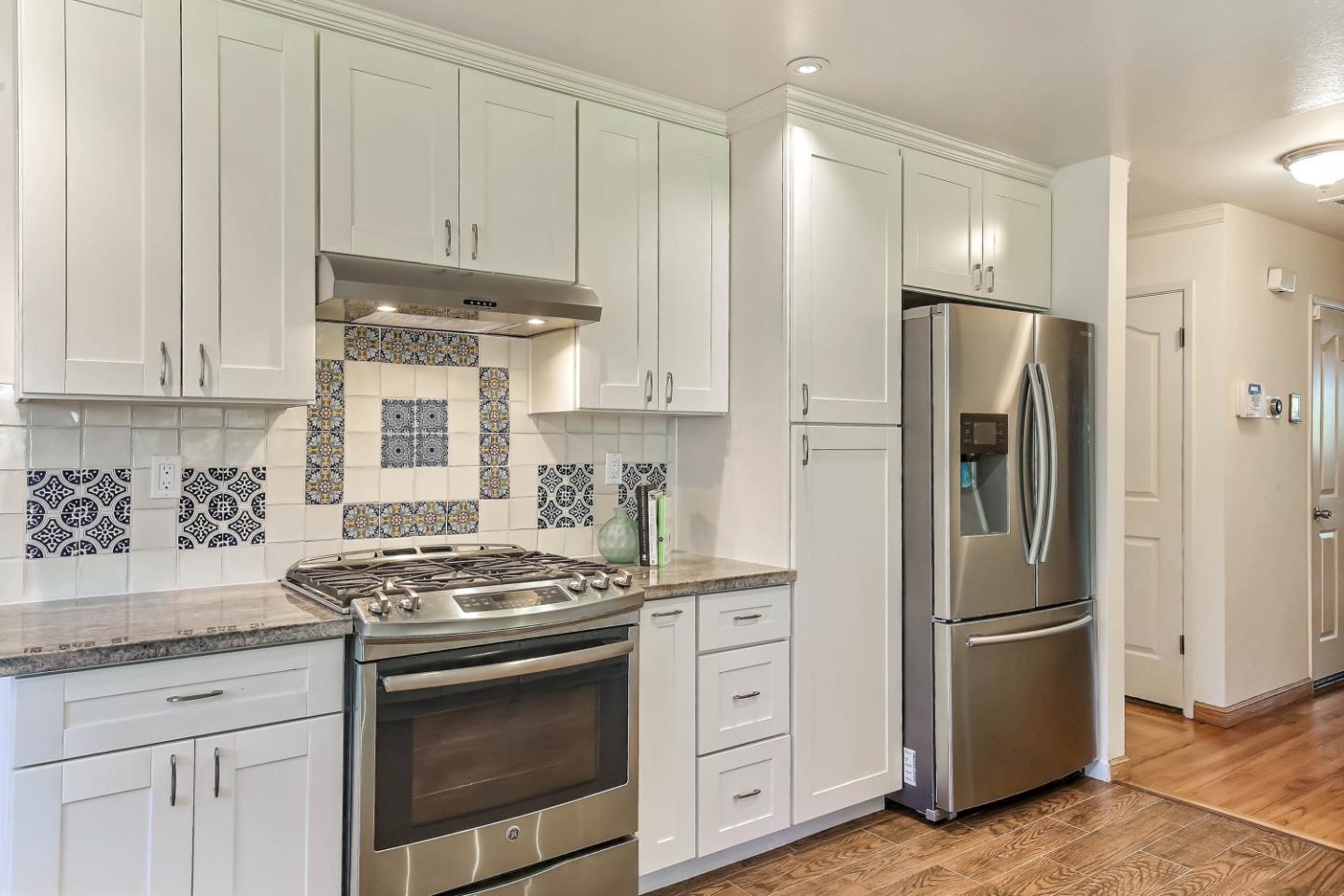 3666 Kirk Road San Jose, CA 95124 - Photo 4 of 13 a kitchen with stainless steel appliances granite countertop a stove a refrigerator and a white cabinets