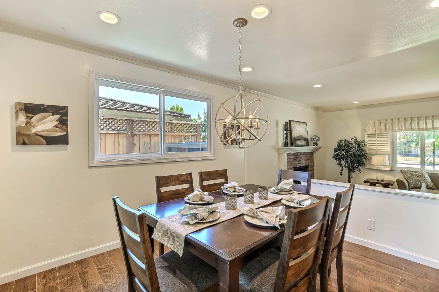 3666 Kirk Road San Jose, CA 95124 - Photo 6 of 13 a dining room with wooden floor a chandelier a wooden table and chairs
