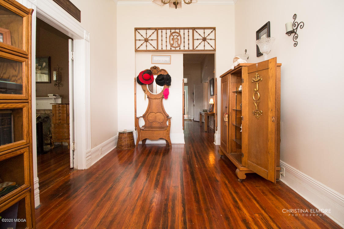 6807 Houston Road Macon, GA 31216 - Photo 3 of 38 a view of a hallway with wooden floor and staircase