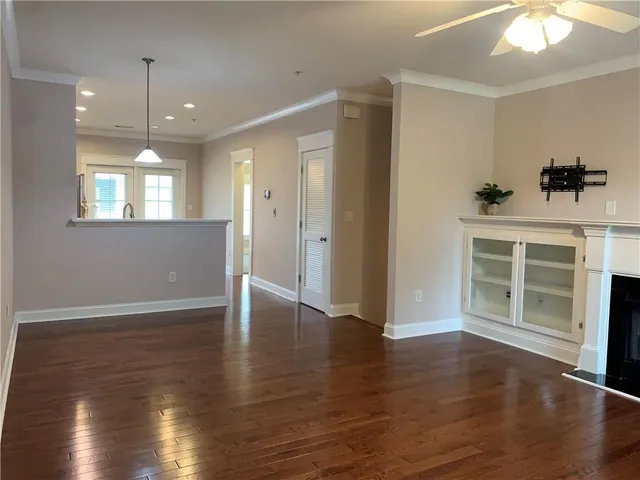 a living room with a fireplace and wooden floor