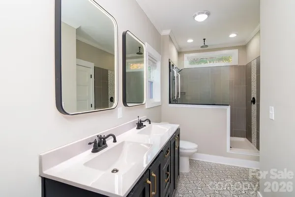 a bathroom with a sink a toilet and a mirror