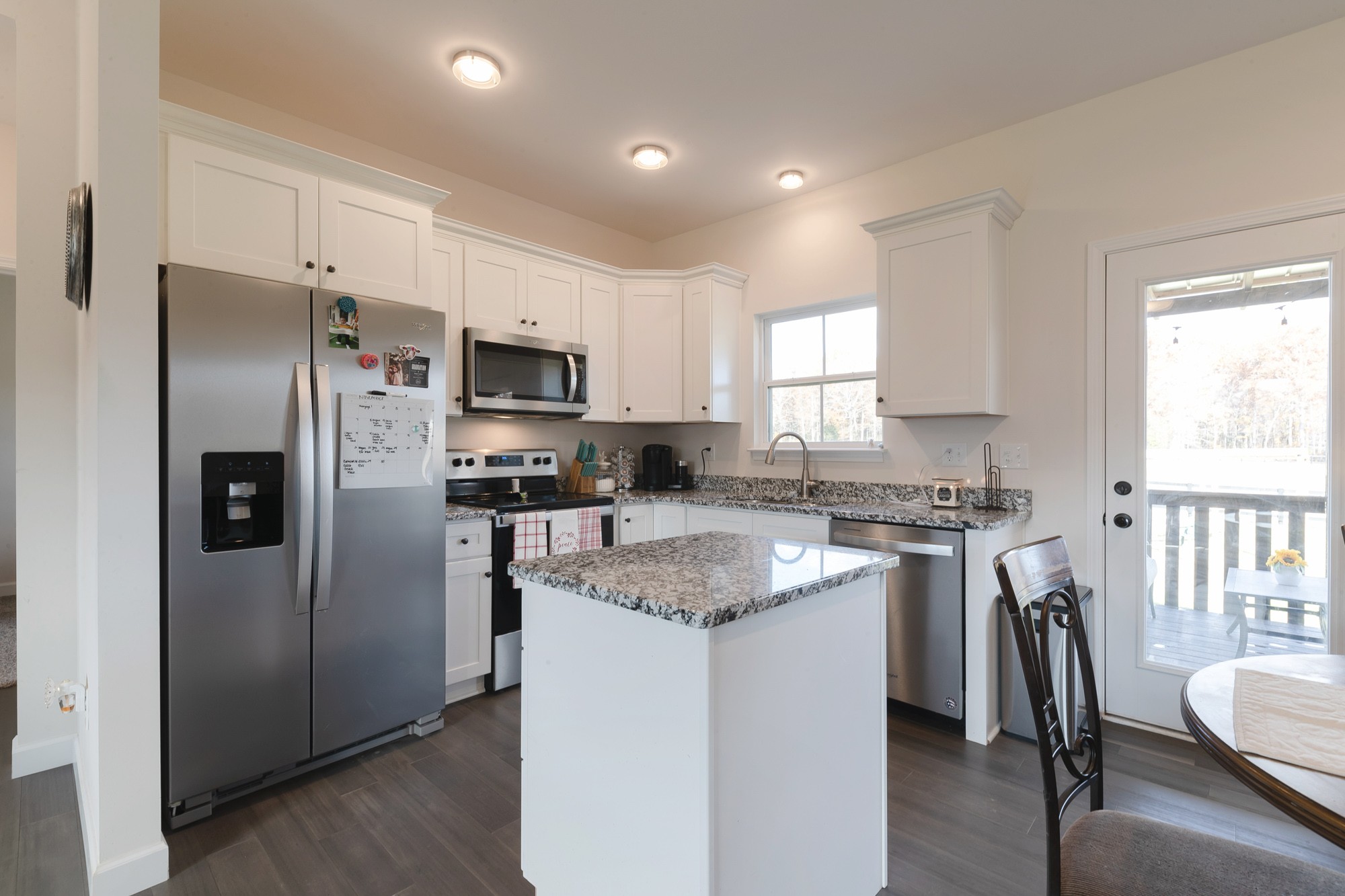 425 Pruett Road Dickson, TN 37055 - Photo 17 of 31 a kitchen with stainless steel appliances granite countertop a refrigerator a stove a sink a dining table and chairs