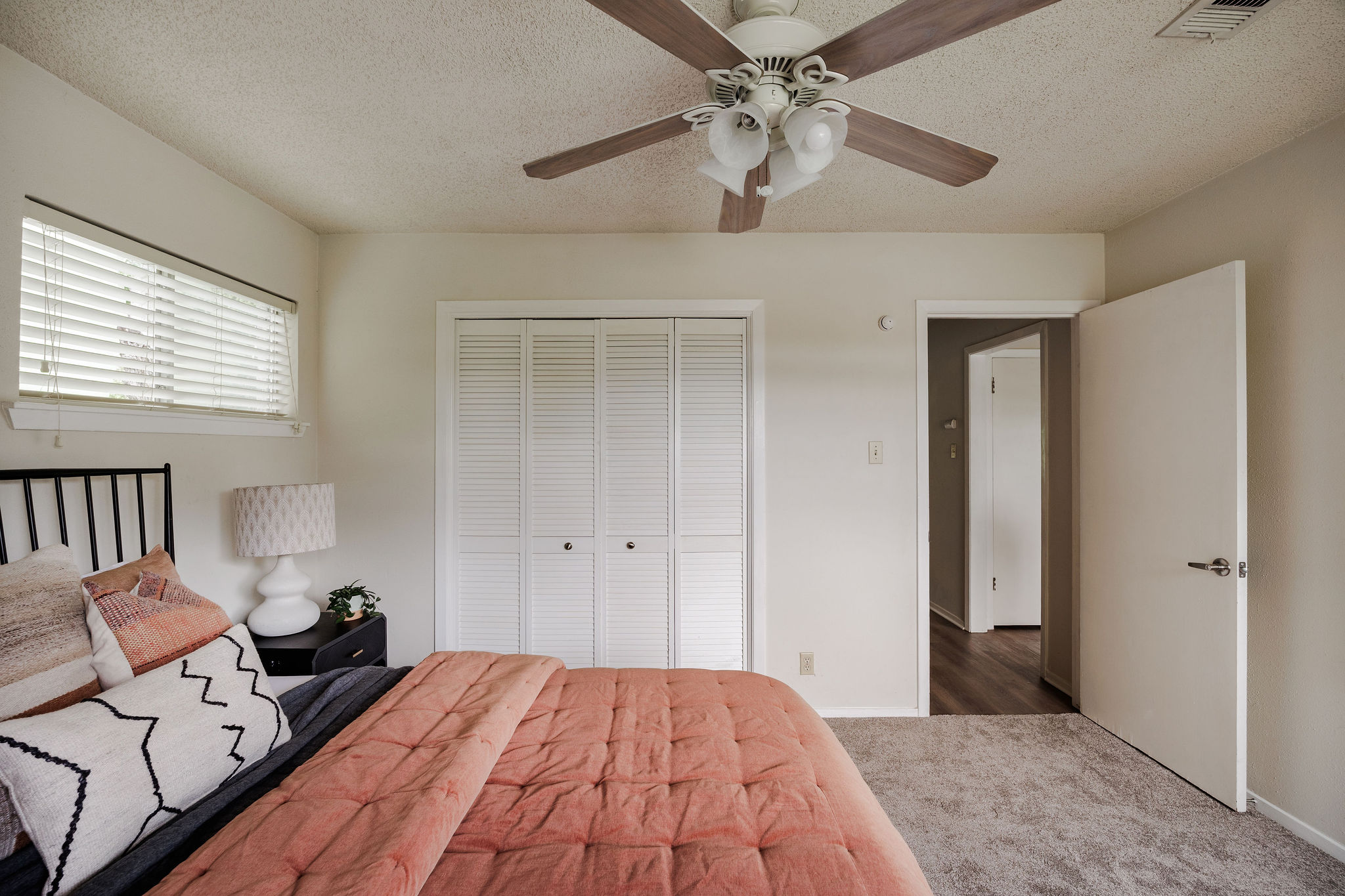 2012 Cody Court Austin, TX 78704 - Photo 16 of 40 A well-lit bedroom features plush carpeting and a convenient ceiling fan for ultimate comfort.