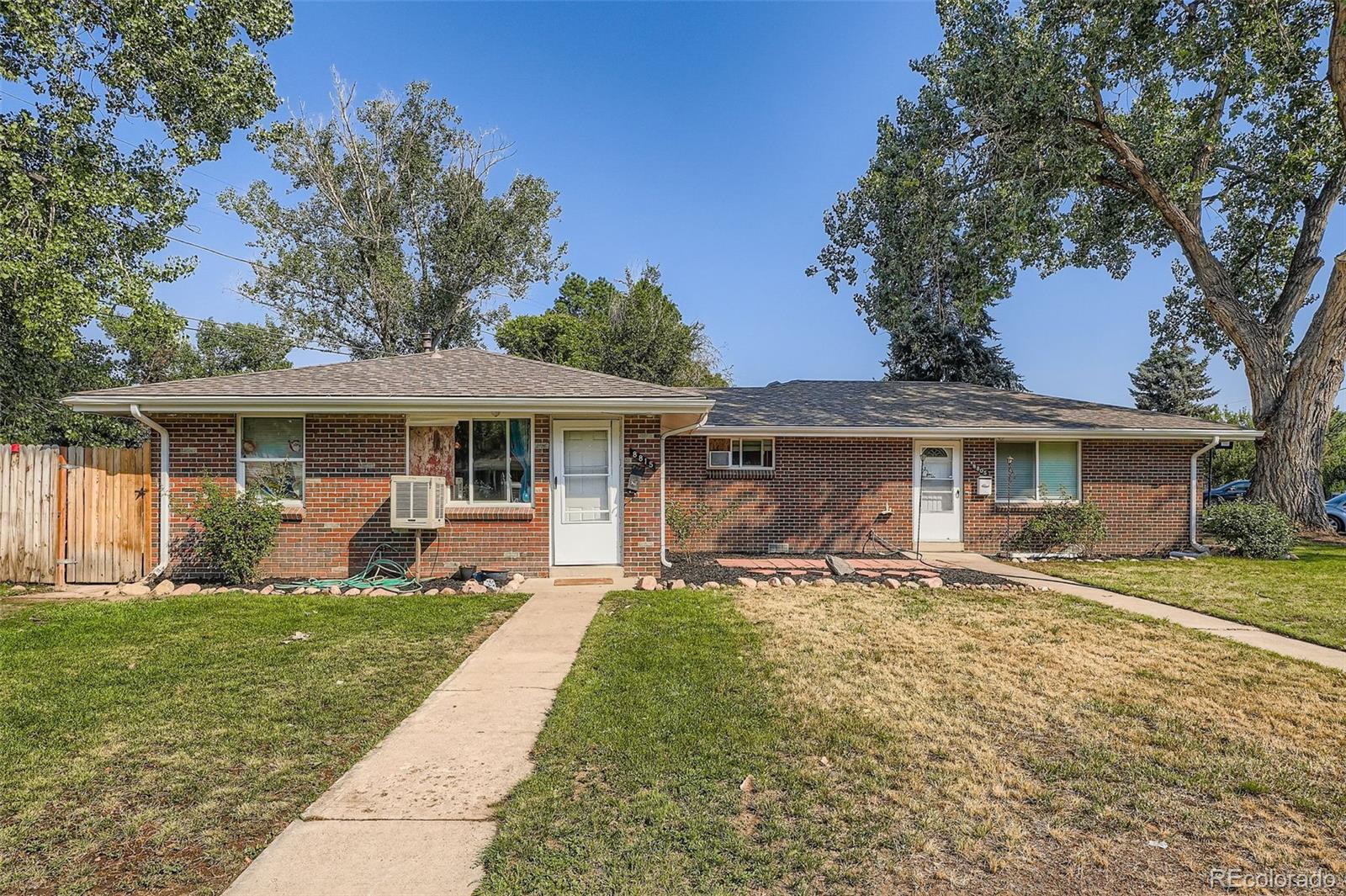 8805 West 46th Avenue Wheat Ridge, CO 80033 - Photo 2 of 25 front view of a house with a yard