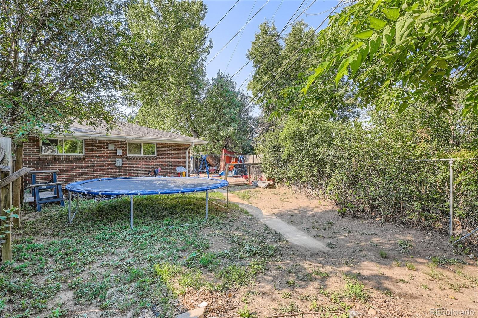 8805 West 46th Avenue Wheat Ridge, CO 80033 - Photo 23 of 25 a view of a house with backyard porch and sitting area