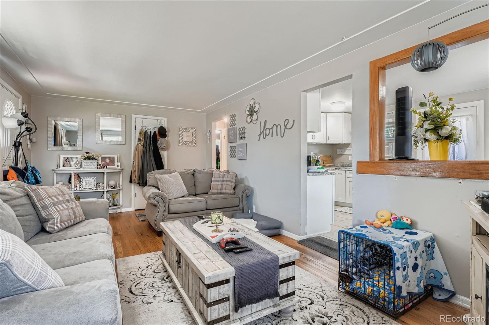 8805 West 46th Avenue Wheat Ridge, CO 80033 - Photo 5 of 25 a living room with furniture and a table