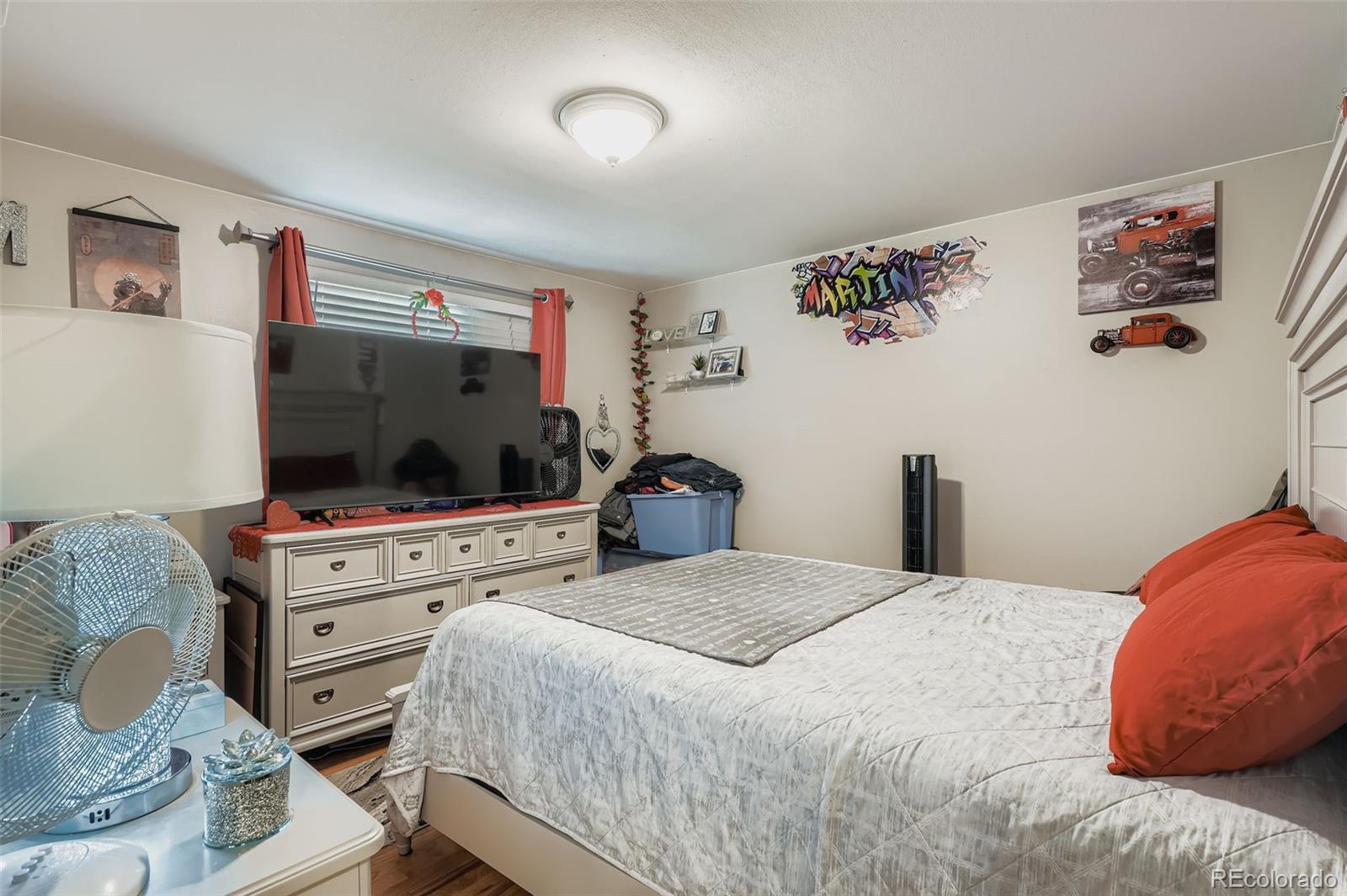 8805 West 46th Avenue Wheat Ridge, CO 80033 - Photo 8 of 25 a bedroom with a bed and a flat screen tv