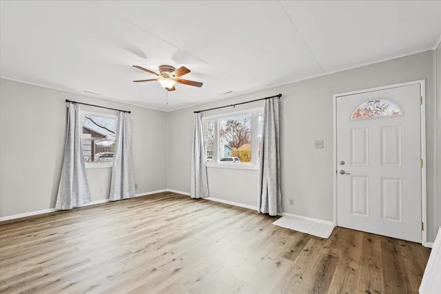 wooden floor in an empty room with a window
