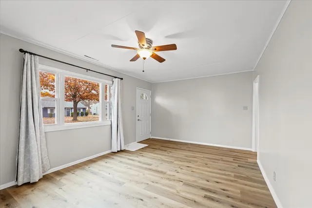 wooden floor in an empty room with a window
