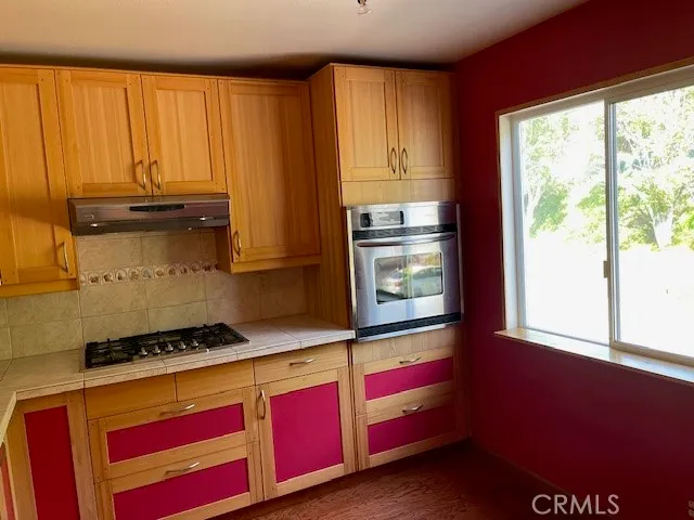 a kitchen with stainless steel appliances granite countertop a sink and cabinets