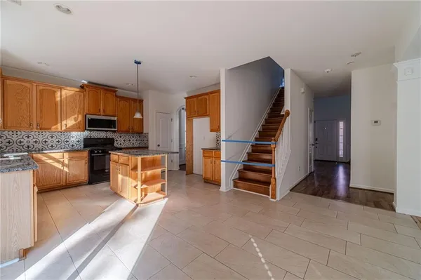 a view of kitchen with microwave and cabinets